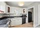 Bright kitchen boasts white cabinetry, dark countertops, modern appliances, and tiled floors at 604 Meadowbrook Rd, Kings Mountain, NC 28086