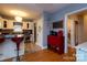 Cozy kitchen featuring a breakfast bar, red accents, and hardwood floors at 604 Meadowbrook Rd, Kings Mountain, NC 28086