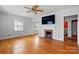 Bright living room featuring hardwood floors, a fireplace, and large windows at 604 Meadowbrook Rd, Kings Mountain, NC 28086