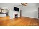Bright living room featuring hardwood floors, fireplace, and a view into the connected kitchen area at 604 Meadowbrook Rd, Kings Mountain, NC 28086