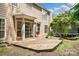 Backyard with wooden deck, lush landscaping, and a trampoline at 6434 Skyline Dr, Charlotte, NC 28269