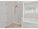 Bathroom featuring a separate shower and soaking tub at 6434 Skyline Dr, Charlotte, NC 28269