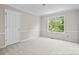 Bedroom with large window, carpet flooring, and white trim at 6434 Skyline Dr, Charlotte, NC 28269