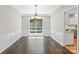 Formal dining area featuring wainscoting, chandelier lighting, and large window at 6434 Skyline Dr, Charlotte, NC 28269