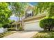 Charming two-story home featuring a two-car garage, neutral siding and lush landscaping at 6434 Skyline Dr, Charlotte, NC 28269