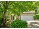Inviting home featuring lush landscaping, stone-lined steps, and a two-car garage at 6434 Skyline Dr, Charlotte, NC 28269