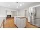 Bright kitchen features a center island, stainless steel appliances, and hardwood flooring at 6434 Skyline Dr, Charlotte, NC 28269