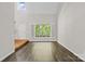 Bright living area featuring hardwood floors, a grand window, and neutral paint at 6434 Skyline Dr, Charlotte, NC 28269