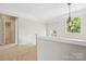 Upstairs hallway features decorative trim, and a view to the outside at 6434 Skyline Dr, Charlotte, NC 28269