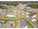Aerial view of a neighborhood with various home styles, landscaping, and a community pool at 7112 Irongate Dr, Indian Land, SC 29707