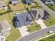 Bird's eye view of beautiful modern home with big driveway, manicured lawn, and mature landscaping in a planned community at 7112 Irongate Dr, Indian Land, SC 29707