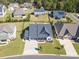 Aerial view of a beautiful home with a well-manicured lawn, a long driveway, and surrounded by mature trees at 7112 Irongate Dr, Indian Land, SC 29707