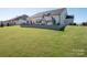 Expansive backyard featuring a lush green lawn and a fun playset for outdoor enjoyment at 7112 Irongate Dr, Indian Land, SC 29707