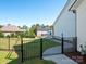 Landscaped backyard with iron fencing, lush lawn and an inviting stone walkway at 7112 Irongate Dr, Indian Land, SC 29707