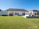 Serene backyard with lush green grass and a playset, perfect for Gathering fun and relaxation at 7112 Irongate Dr, Indian Land, SC 29707