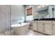 This bathroom features both a shower and soaking tub, with large cabinets for storage at 7112 Irongate Dr, Indian Land, SC 29707