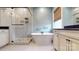An ensuite bath features a standalone soaking tub and a glass-enclosed shower at 7112 Irongate Dr, Indian Land, SC 29707