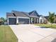 Spacious driveway leading to a home with a two-car garage and landscaped front yard at 7112 Irongate Dr, Indian Land, SC 29707