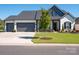 Charming two-story home with a three-car garage, beautiful landscaping, and inviting front porch at 7112 Irongate Dr, Indian Land, SC 29707