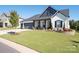 Charming single-Gathering home featuring manicured lawn and classic architectural details at 7112 Irongate Dr, Indian Land, SC 29707