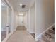 Inviting foyer with carpeted floors, light-filled entry, and staircase leading to upper level at 7112 Irongate Dr, Indian Land, SC 29707