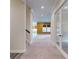 Bright hallway featuring carpeted floors, an adjacent staircase, and clear view into another room at 7112 Irongate Dr, Indian Land, SC 29707