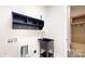 Functional laundry room featuring a utility sink, storage cabinet and shelving at 7112 Irongate Dr, Indian Land, SC 29707