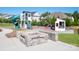 Community playground featuring a playset with slides and a swing set, and a firepit seating area at 7112 Irongate Dr, Indian Land, SC 29707