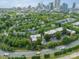 A scenic aerial view of residential community nestled among lush greenery with a cityscape backdrop at 738 Garden District Dr, Charlotte, NC 28202