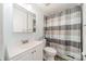 Bathroom with white vanity, toilet, mirror, and a neutral colored shower curtain at 738 Garden District Dr, Charlotte, NC 28202