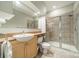 Bathroom featuring a sink with wood cabinets, a toilet, and a tiled shower with glass doors at 738 Garden District Dr, Charlotte, NC 28202