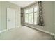 Bedroom with large windows, soft carpet, and built in shelving at 738 Garden District Dr, Charlotte, NC 28202