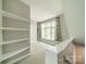 Bedroom featuring neutral walls, built in shelves, and a window at 738 Garden District Dr, Charlotte, NC 28202