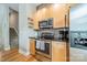 Updated kitchen featuring stainless steel appliances, wooden cabinetry, and tile backsplash at 738 Garden District Dr, Charlotte, NC 28202