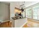 Bright kitchen with black countertops, stainless steel appliances, and large windows with wooden shutters at 738 Garden District Dr, Charlotte, NC 28202
