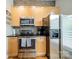 Kitchen with stainless steel appliances, wood cabinets, and tile backsplash at 738 Garden District Dr, Charlotte, NC 28202