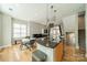 Open floor plan showcasing a kitchen with granite countertops flowing into a dining and living area at 738 Garden District Dr, Charlotte, NC 28202