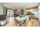 Open-concept living area with hardwood floors, modern furnishings, and an adjacent kitchen at 738 Garden District Dr, Charlotte, NC 28202