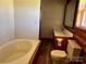 Bathroom featuring a tub, sink with vanity, toilet and framed mirror at 8464 Robinson Church Rd, Charlotte, NC 28215