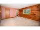 Bedroom featuring a neutral carpet, wood trim, and a view of the outdoors at 8464 Robinson Church Rd, Charlotte, NC 28215