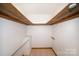 Bright, walk-in closet featuring ample shelving and hanging storage space for optimal organization at 8464 Robinson Church Rd, Charlotte, NC 28215