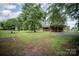 Secluded log cabin home nestled on a sprawling lot with mature trees and ample privacy at 8464 Robinson Church Rd, Charlotte, NC 28215