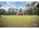 Quaint log cabin home nestled on a large lot with mature trees, offering privacy at 8464 Robinson Church Rd, Charlotte, NC 28215