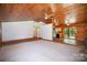 Spacious living room with wood ceilings and trim, a neutral carpet, and an open layout at 8464 Robinson Church Rd, Charlotte, NC 28215