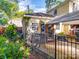 Landscaped backyard featuring a small outbuilding, fenced area, and partial awning at 907 Edgewood Cir, Gastonia, NC 28052
