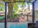 Backyard patio with a gate, and landscaped area; shaded by a large tree at 907 Edgewood Cir, Gastonia, NC 28052