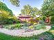 Picturesque backyard featuring a serene pond, lush plants, rock accents, and manicured lawn at 907 Edgewood Cir, Gastonia, NC 28052
