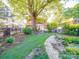 Expansive backyard with a lovely pond, grassy lawn, mature trees, and neighborhood views at 907 Edgewood Cir, Gastonia, NC 28052