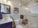 Bathroom featuring a glass-enclosed shower, dark vanity, and modern fixtures at 907 Edgewood Cir, Gastonia, NC 28052
