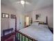 Comfortable bedroom featuring a four-poster bed, ceiling fan, and a doorway leading to additional rooms at 907 Edgewood Cir, Gastonia, NC 28052